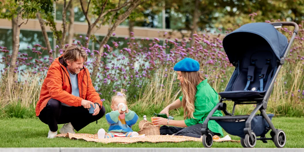 Kleine Familie bei gemütlichem Picknick mit Joolz Aer+ in Navy Blue im Vordergrund